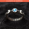 Silver moon phases moonstone ring . A silver ring with a round blue moonstone centerpiece. The ring has a textured band and a polished finish.